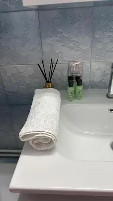a white towel sitting on top of a bathroom counter at Modern apartment in Neo Faliro in Piraeus