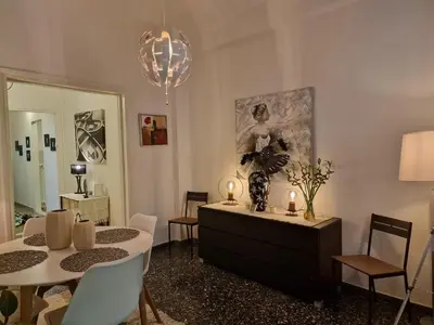 a living room with a table and a dining room at Modern apartment in Neo Faliro in Piraeus