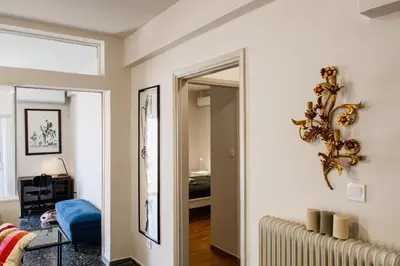 a living room with a mirror and a hallway at Stylish and cozy flat at pagrati in Athens