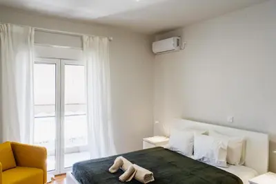 a bedroom with a bed with two towels on it at Stylish and cozy flat at pagrati in Athens