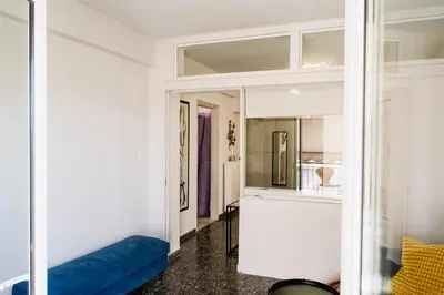 a living room with a blue couch and a mirror at Stylish and cozy flat at pagrati in Athens