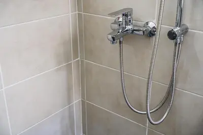 a shower with a shower head in a bathroom at Stylish and cozy flat at pagrati in Athens