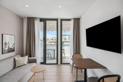 a living room with a couch and a table at Limehome Piraeus Olive in Piraeus