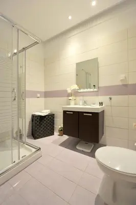 a bathroom with a shower and a sink and a toilet at My Athens House in Athens