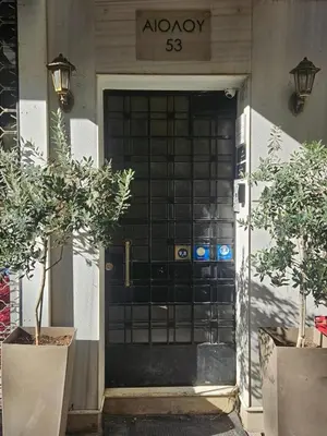 a black front door of a building with potted plants at My Athens House in Athens