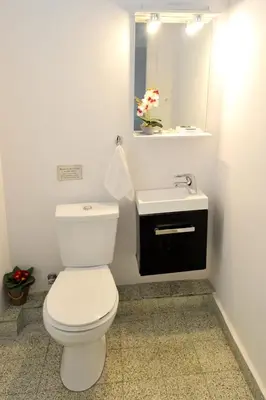 a bathroom with a white toilet and a sink at My Athens House in Athens