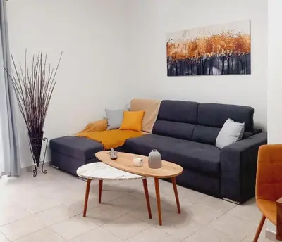 a living room with a blue couch and a table at RELAX & RECHARGE apartment 1 in Athens