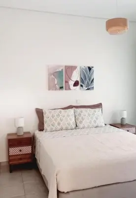 a bedroom with a bed and two pictures on the wall at RELAX & RECHARGE apartment 1 in Athens