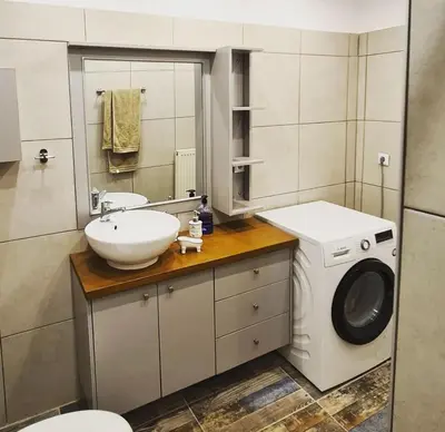 a bathroom with a washing machine and a sink at Betty s House Porto Rafti in Porto Rafti