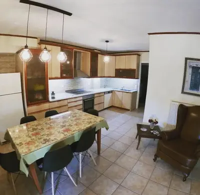 a kitchen with a table and chairs in a room at Betty s House Porto Rafti in Porto Rafti