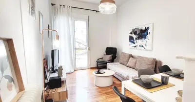 a living room with a couch and a table at Διαμέρισμα στο Θησείο in Athens