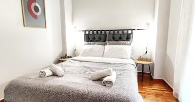 a bedroom with a large bed with two towels on it at Διαμέρισμα στο Θησείο in Athens