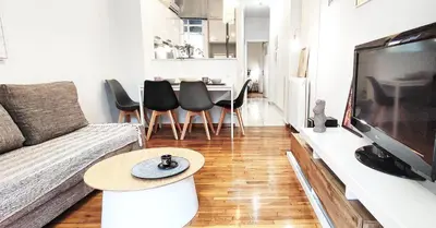 a living room with a couch and a table at Διαμέρισμα στο Θησείο in Athens