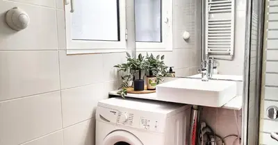 a small bathroom with a sink and a washing machine at Διαμέρισμα στο Θησείο in Athens