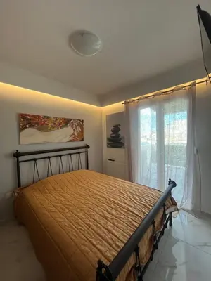 a bedroom with a bed and a window at Panos Loft With Acropolis View in Athens