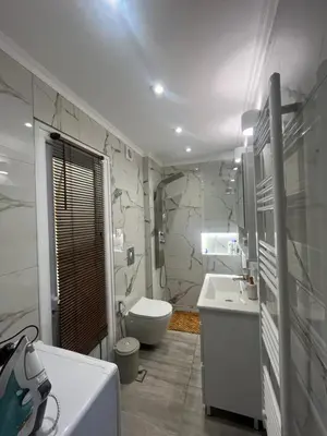 a white bathroom with a toilet and a sink at Panos Loft With Acropolis View in Athens