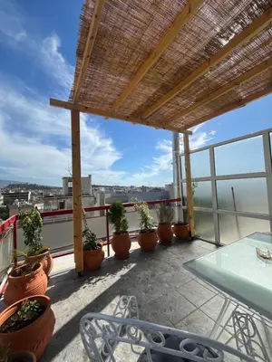 a balcony with a table and potted plants on it at Panos Loft With Acropolis View in Athens