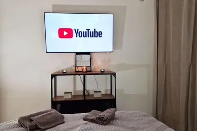 a television on top of a bed in a room at Daphnes Crown in Athens