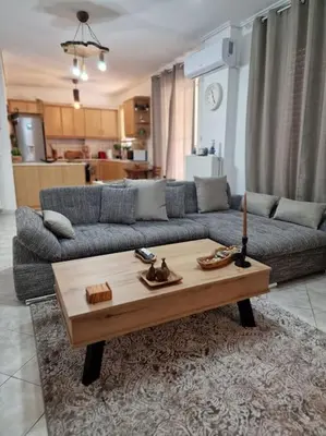 a living room with a couch and a coffee table at Daphnes Crown in Athens