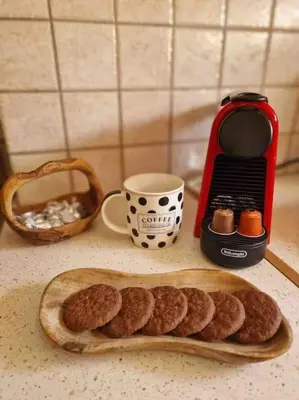 a table with a plate of cookies and a coffee maker at Daphnes Crown in Athens