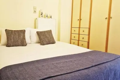 a bedroom with a bed with two pillows at Daphnes Crown in Athens