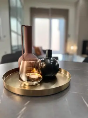 a tray with a candle and a bottle on a table at Estia Athens Apartment in Athens