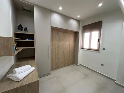 a hallway with a wooden door and a window at Estia Athens Apartment in Athens