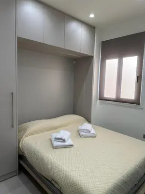 a bedroom with a bed with two towels on it at Estia Athens Apartment in Athens