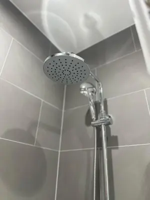 a shower with a shower head in a bathroom at Estia Athens Apartment in Athens