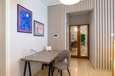 a dining room with a table and a dog in the window at Luxury 2 bed Urban Oasis in the Heart of Athens in Athens