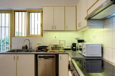 a kitchen with a sink and a microwave at Luxury 2 bed Urban Oasis in the Heart of Athens in Athens