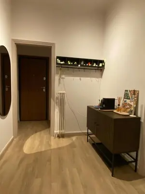 a room with a desk and a hallway with a door at Veli's Apartment in Athens