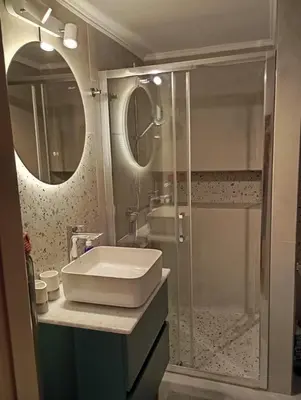 a bathroom with a sink and a shower at Veli's Apartment in Athens