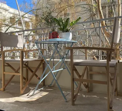 a table and two chairs on a balcony at Veli's Apartment in Athens