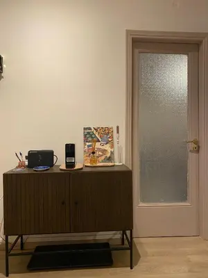 a wooden cabinet with a window in a room at Veli's Apartment in Athens