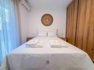 a bedroom with a white bed with towels on it at Elegant Flat in Glyfada Center in Athens