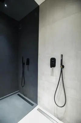 a bathroom with a shower with a hose on the wall at Syntagma Luxe Loft in Athens