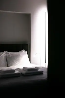 a bed with two towels sitting on top of it at Syntagma Luxe Loft in Athens