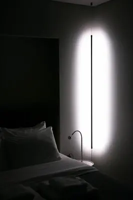 a bedroom with a bed with a light shining through a window at Syntagma Luxe Loft in Athens