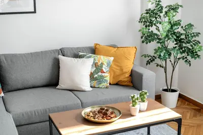 a living room with a gray couch and a table at Dew 1-Bedroom Apartment in Athens in Athens