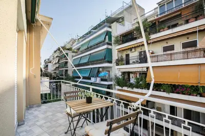 a balcony of a building with a table and benches at Dew 1-Bedroom Apartment in Athens in Athens
