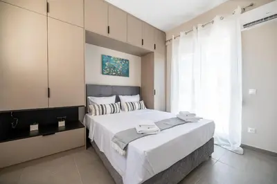 a bedroom with a large bed with white sheets at Central apartment 5min from Omonoia Subway Station in Athens
