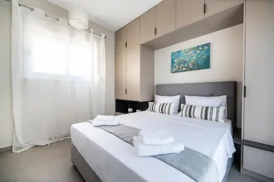 a bedroom with a large white bed with two pillows at Central apartment 5min from Omonoia Subway Station in Athens