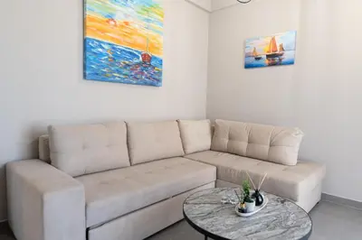 a living room with a couch and a table at Central apartment 5min from Omonoia Subway Station in Athens