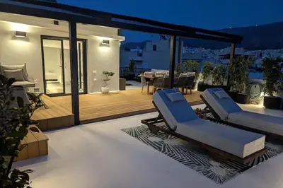 a patio with two lounge chairs and a table at Loft with Panoramic View near the center of Athens in Athens