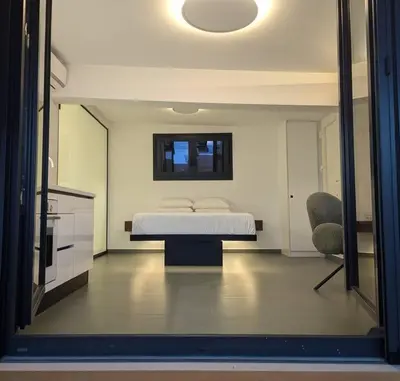 a bedroom with a bed and a table and a mirror at Loft with Panoramic View near the center of Athens in Athens