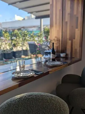 a table with two glasses and a bottle of wine at Loft with Panoramic View near the center of Athens in Athens