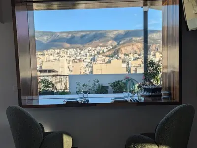 a view of a city from a large window at Loft with Panoramic View near the center of Athens in Athens