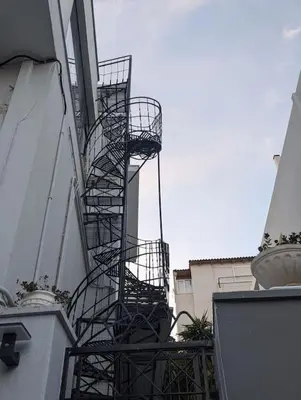 a spiral staircase on the side of a building at Loft with Panoramic View near the center of Athens in Athens