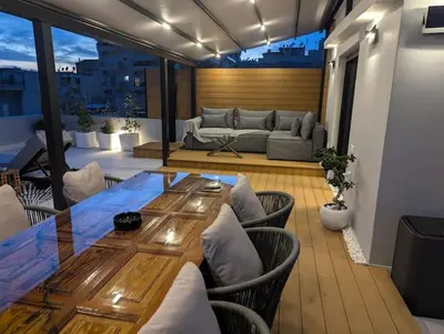 a living room with a table and chairs and a couch at Loft with Panoramic View near the center of Athens in Athens